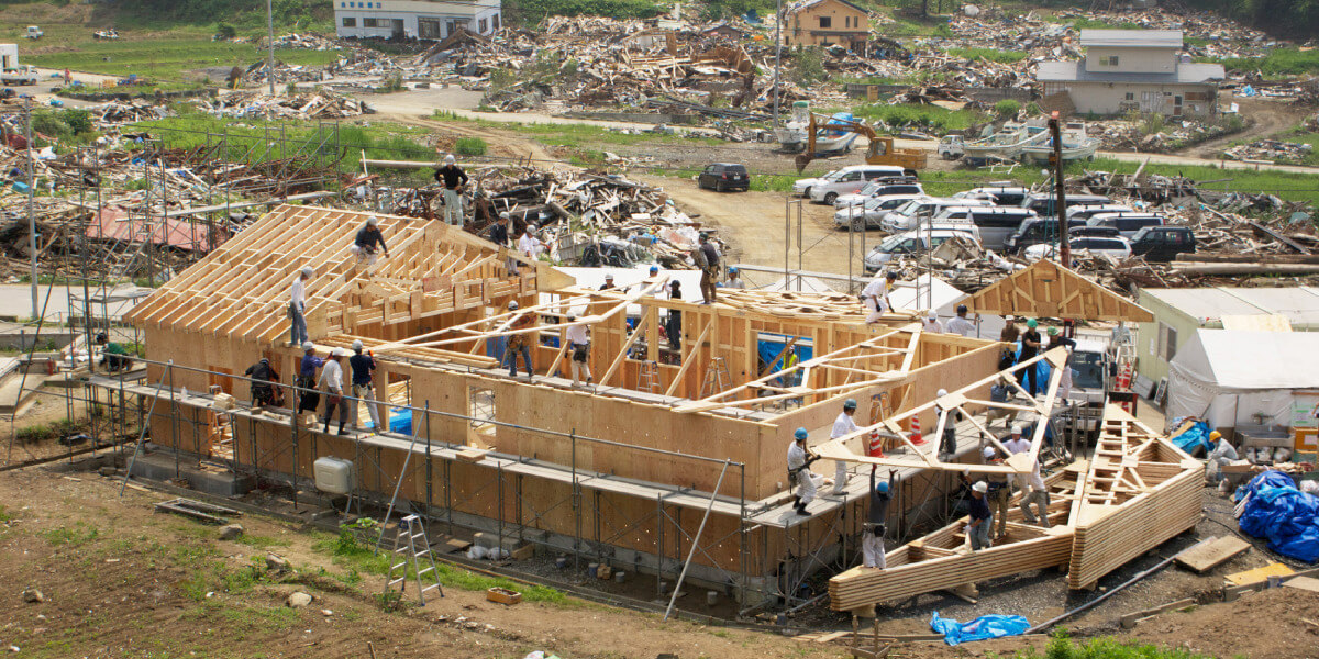 a group of people working on a construction project after an earthquake